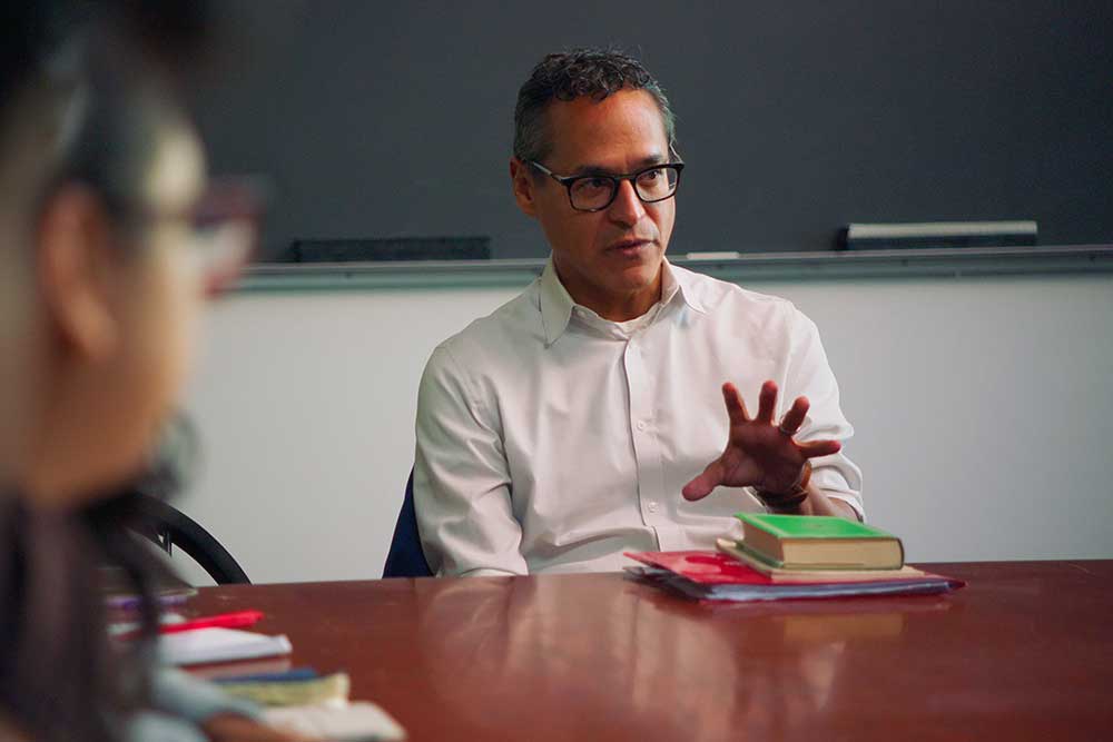 Roosevelt Montas in speaking and gesturing in Class